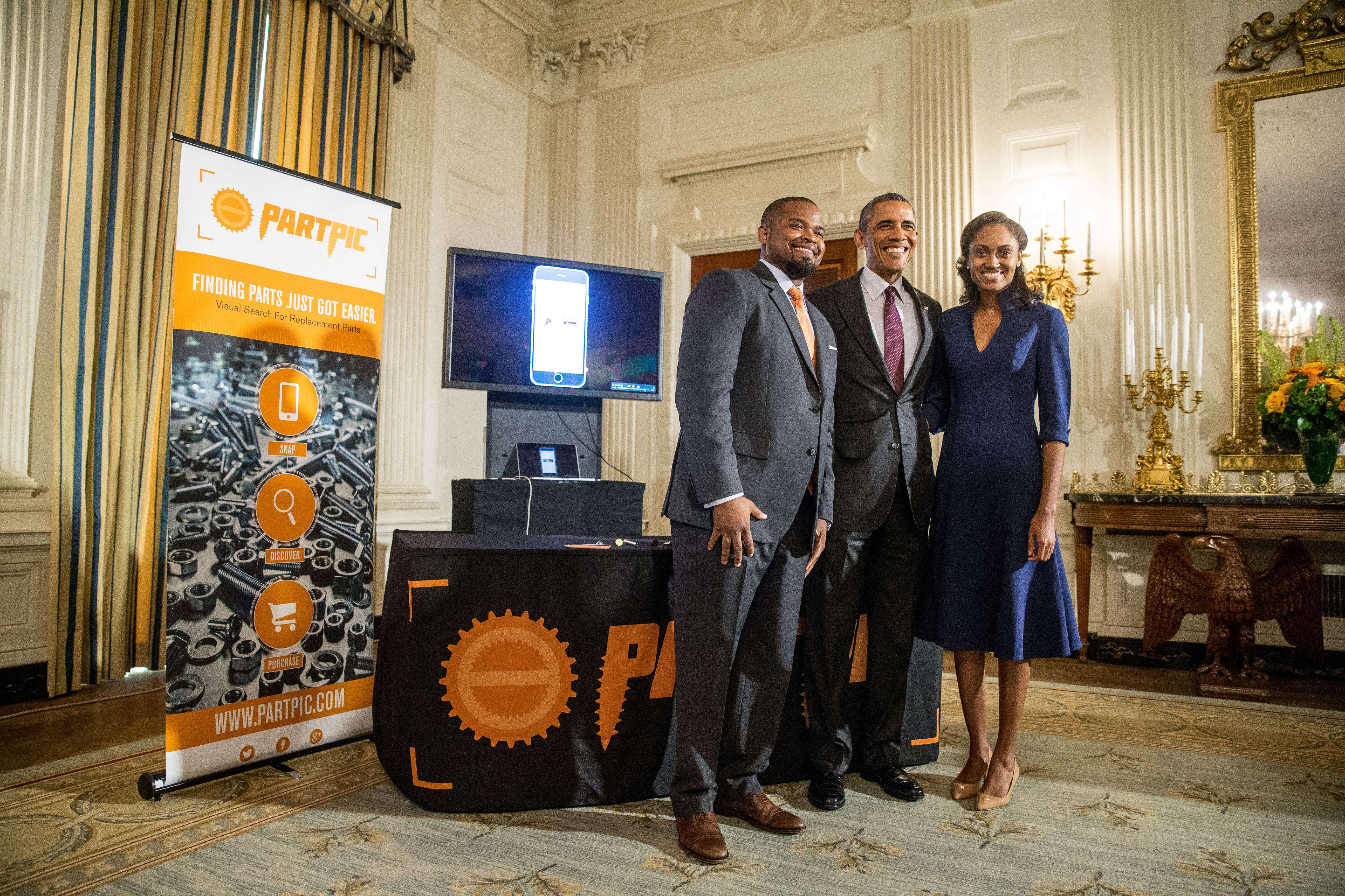 President Barack Obama poses for a photo with Jewel Burks and Jason Crain, Atlanta, Ga. of Partpic, while hosting top innovators and startup founders from across the country for the first White House Demo Day, Aug. 4, 2015, in the State Dinning Room of the White House in Washington. Partpic allows customers to take a picture of a part they want to replace and automatically receive product name, specifications, and supplier information. (AP Photo/Andrew Harnik)